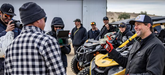 Travis Pastrana (right) puts his money where his mouth is at -- even if it's just a simple dollar bill -- and Brian Deegan (left) says "You're on, that's a bet." Photo: Long Nguyen.